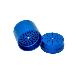 A shiny blue metal grinder is open, showing the top piece with many small teeth and the bottom with holes.