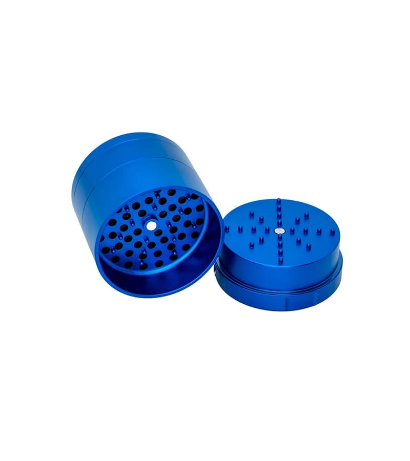 A shiny blue metal grinder is open, showing the top piece with many small teeth and the bottom with holes.