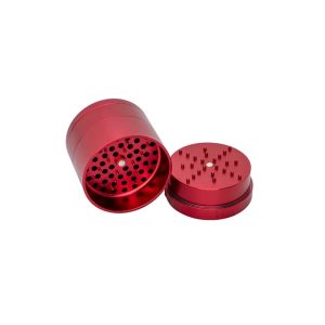 A red metal grinder with a textured top and a bottom piece with numerous small, sharp spikes.