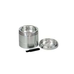 A three-piece silver metal grinder with a lid and a small black brush on a white background.