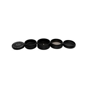 A black, cylindrical, four-piece herb grinder with "STACHE GRYNDER" and a logo on the lid.