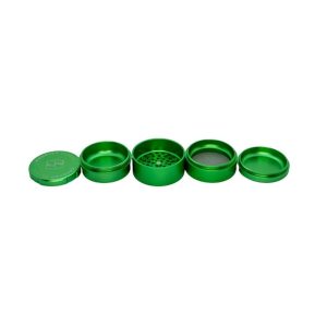 A four-piece green metal herb grinder is disassembled and laid out horizontally on a white background.