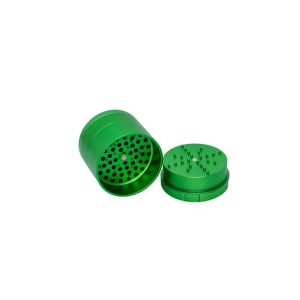 A bright green metal herb grinder is open, showing the top with grinding teeth and the bottom with holes.
