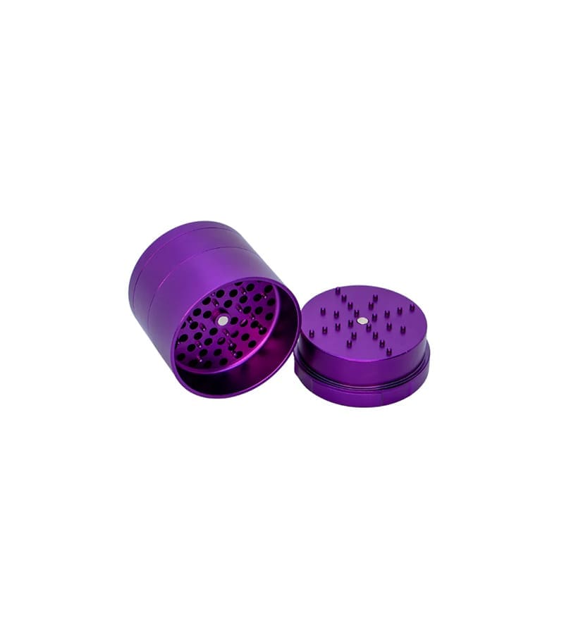 A shiny purple metal grinder is open, revealing a perforated screen and spiked grinding surface.