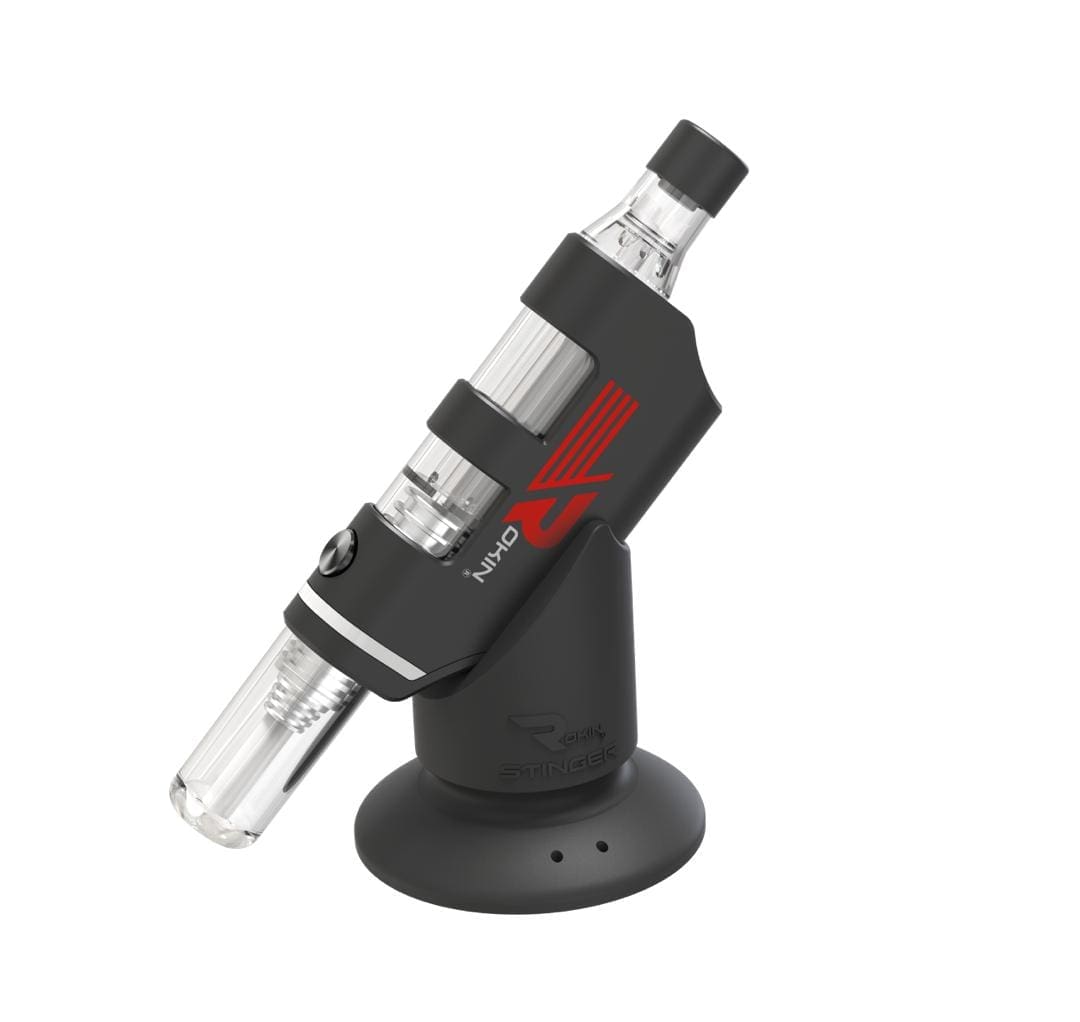 A black and clear "Okin" vape device with a red logo sits on a black "Stinger" charging stand.