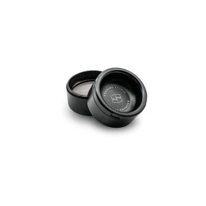 Two black cylindrical grinders are open, with "STACHE GRYNDER" and a logo on the lid.