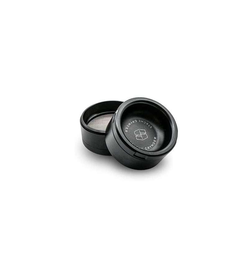 Two black cylindrical grinders are open, with "STACHE GRYNDER" and a logo on the lid.