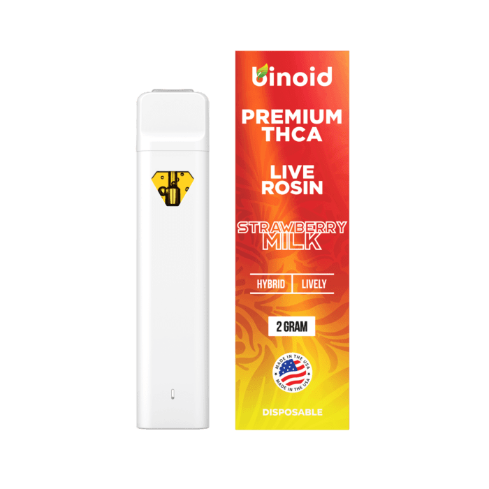 A white vape pen with a yellow diamond logo next to a red and orange box for "STRAWBERRY MILK" flavor.