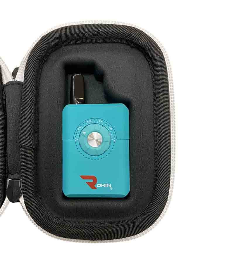 A turquoise "ROKIN" vape with a silver dial and black mouthpiece rests in a black zippered case.