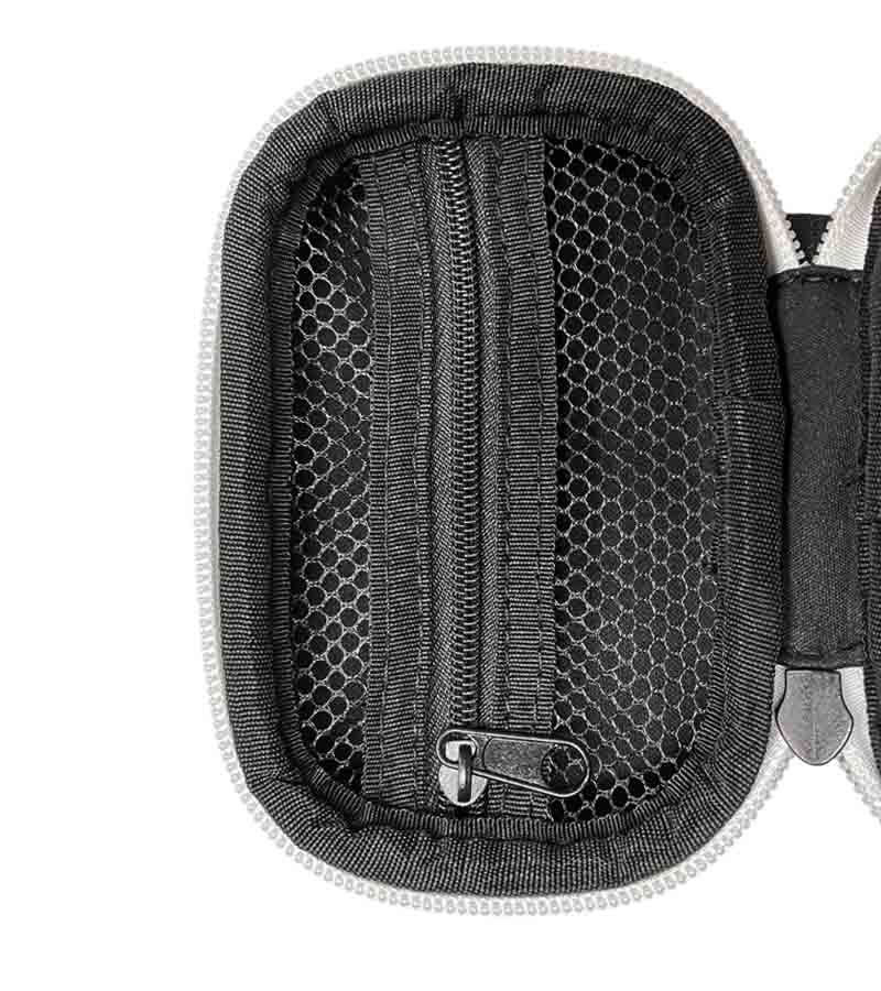 An open black travel case with a mesh pocket, a zipper, and a silver zipper pull.