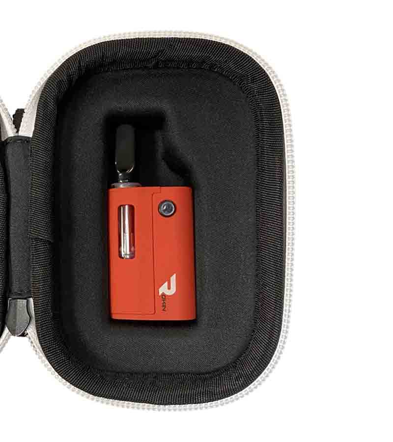 An orange "ROKIN" vape pen with a cartridge and button rests in a black foam case.
