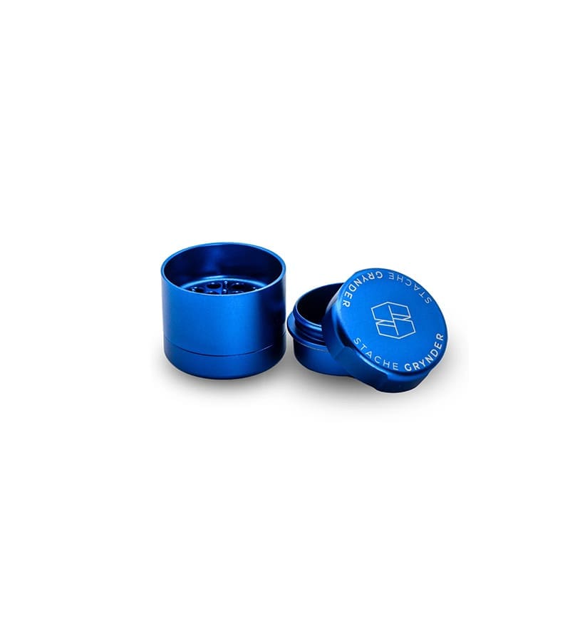 A shiny blue metal grinder with "STACHE GRYNDER" on the lid, on a white background.