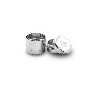 Two shiny silver metal grinders are shown, one open with "STACHE GRYNDER" and a logo on the lid.