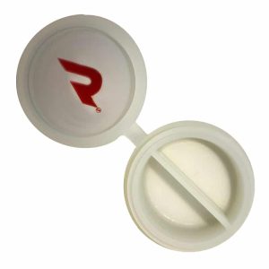 An open white round pill case with a red "R" logo on the lid and two compartments inside.